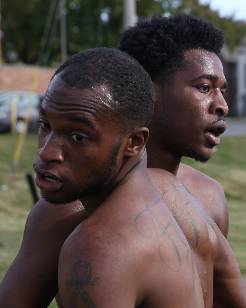Juston Sharp, left, and Isaiah Newton embrace after a boxing match